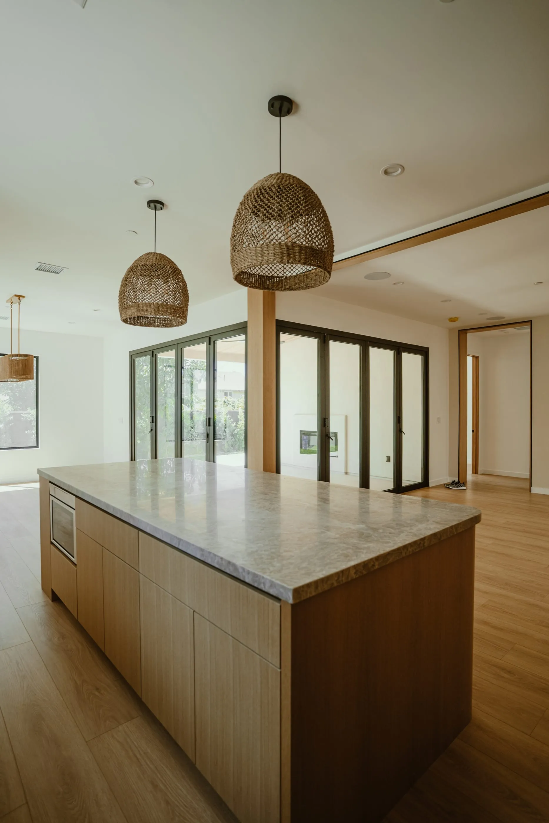 Kitchen island facing folding glass doors and the covered courtyard