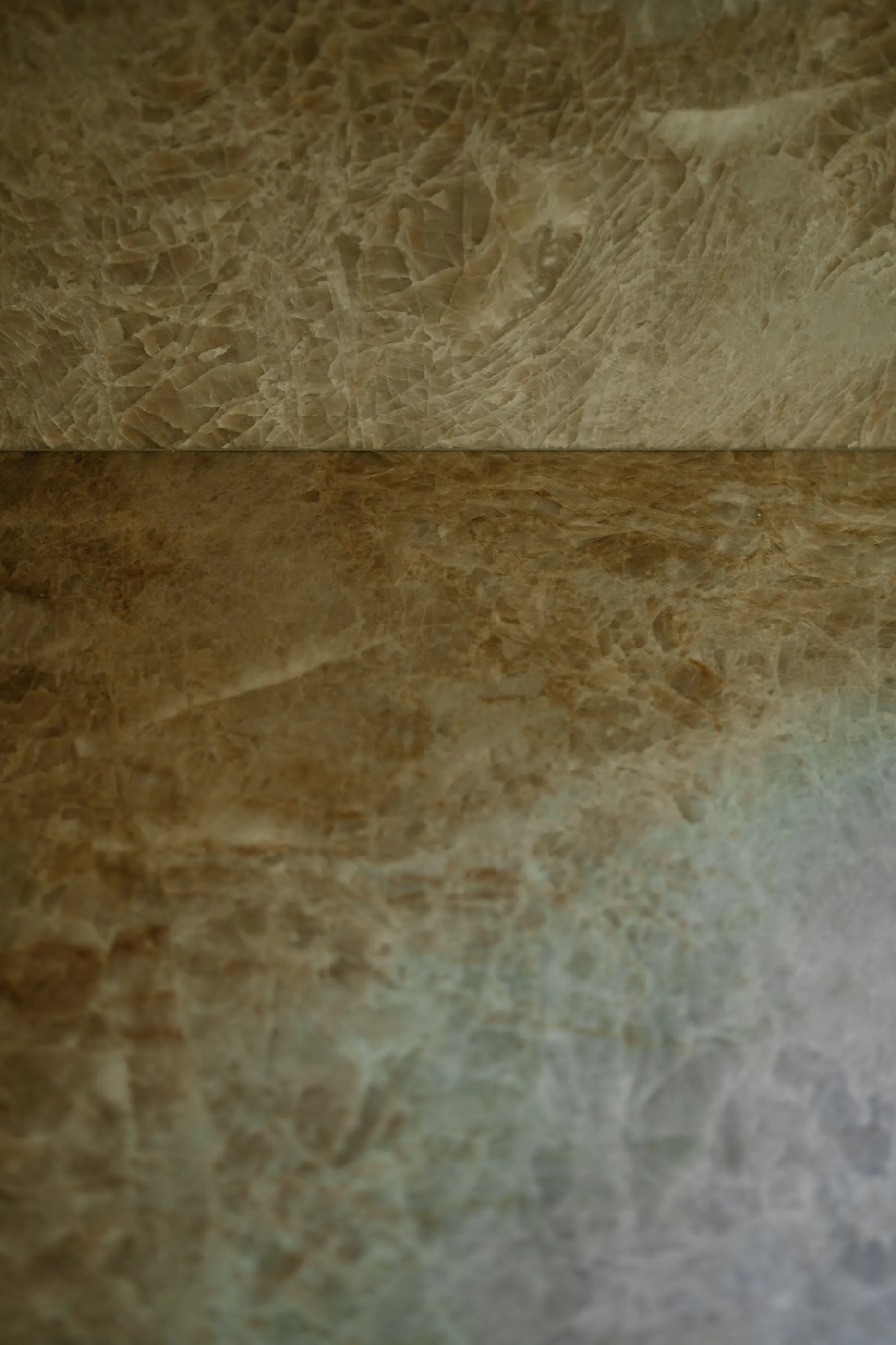 Close view of translucent natural stone surfaces meeting at a corner