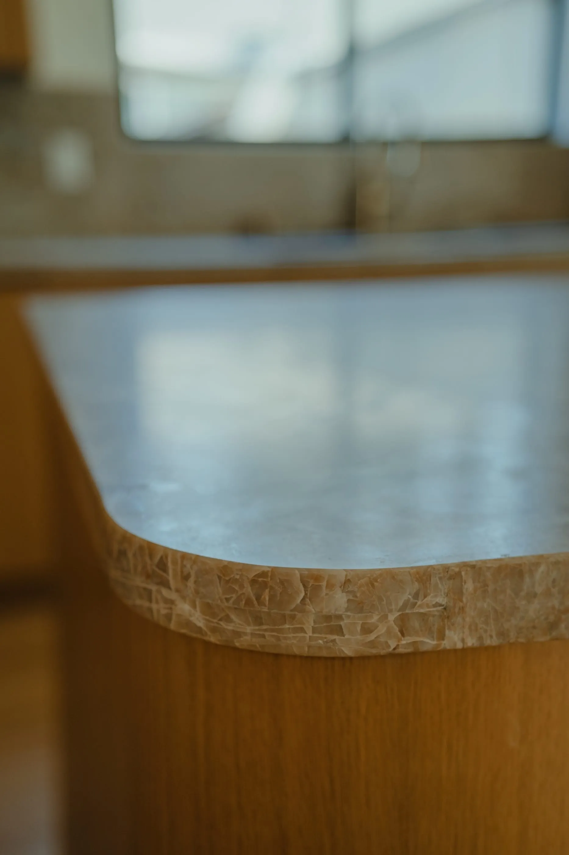 Rounded edge detail where the stone counter meets the oak island
