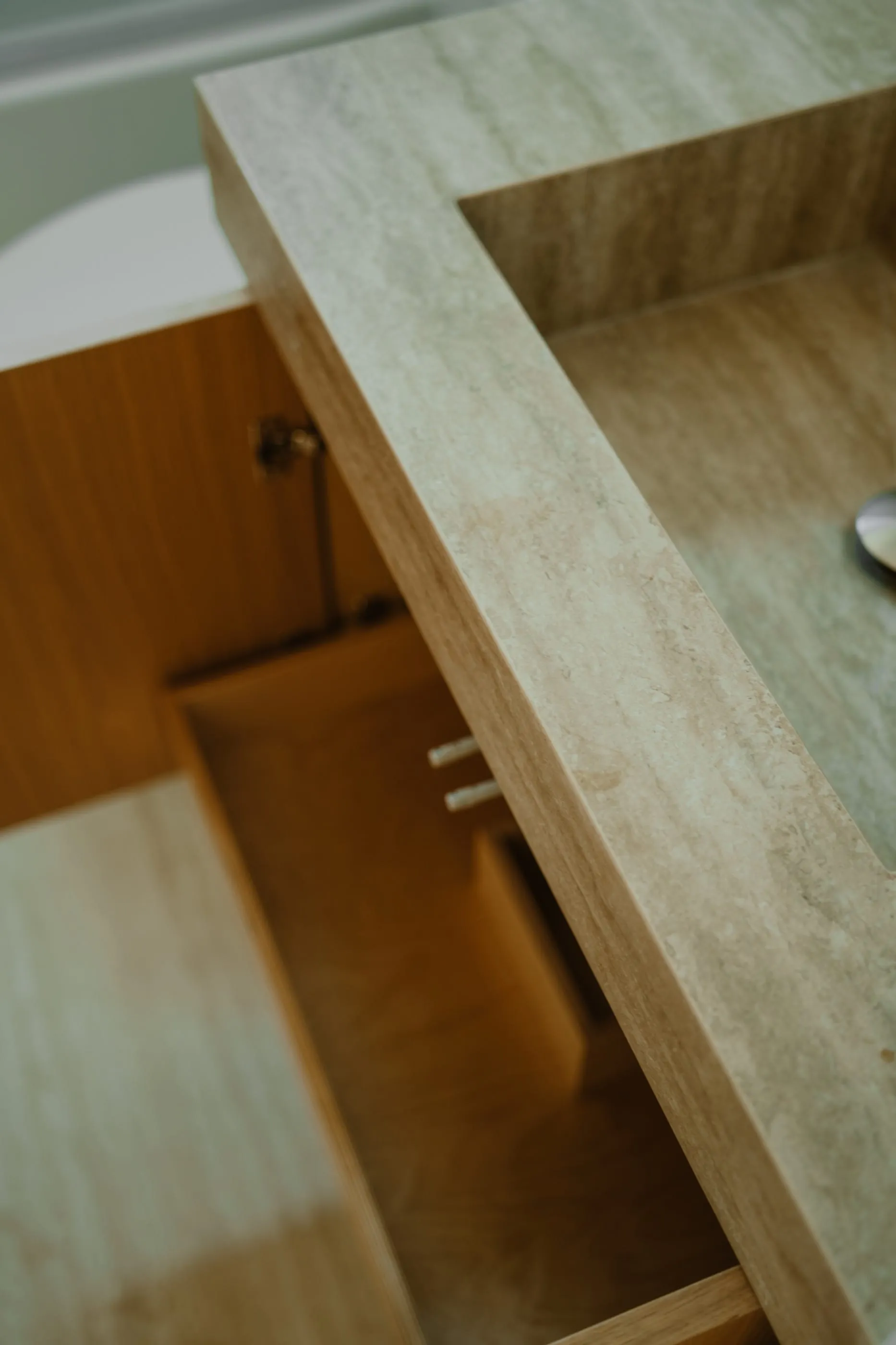 Angled close view of the stone vanity and integrated basin