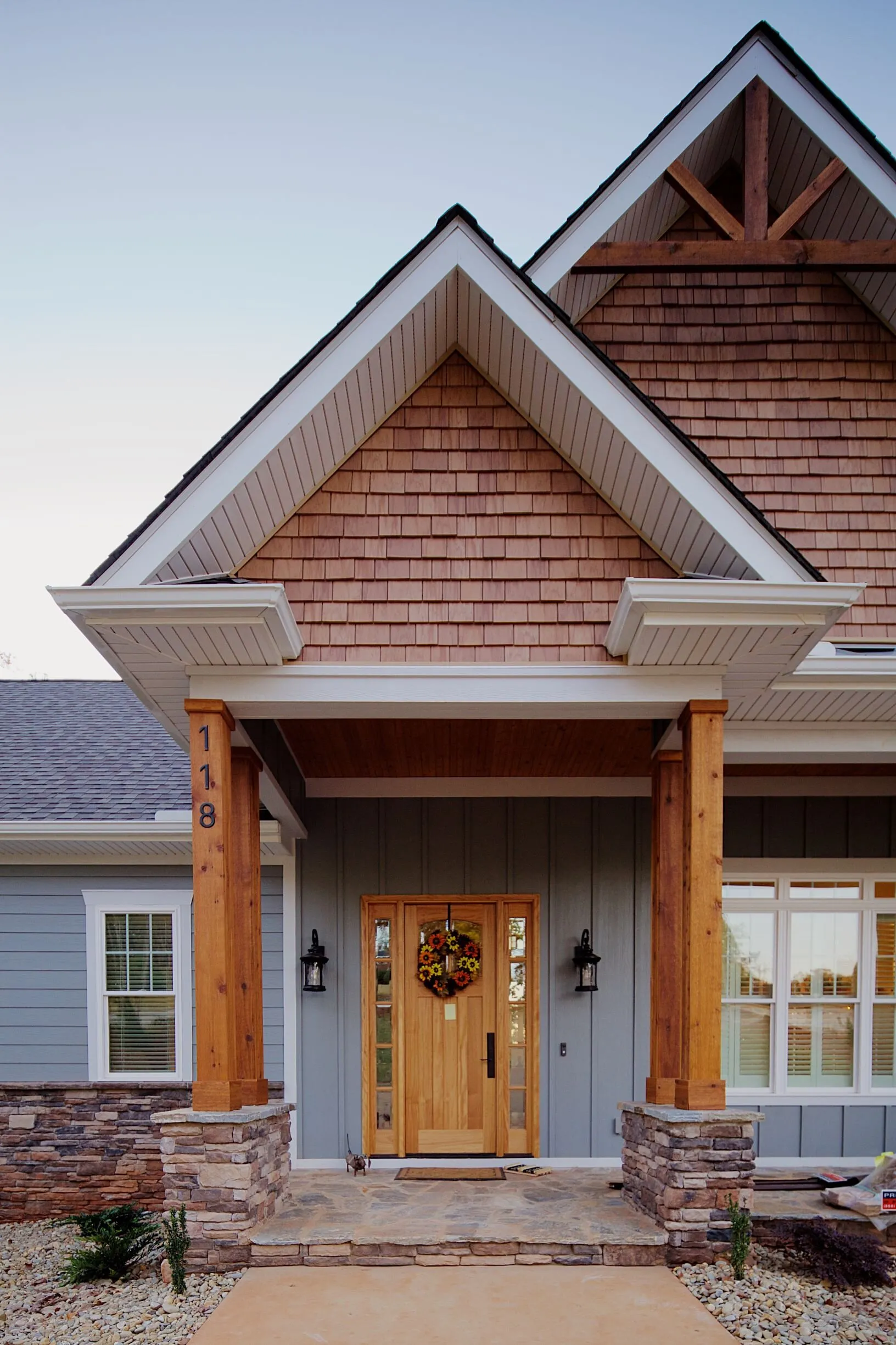 Timber-framed front entry beneath overlapping gables