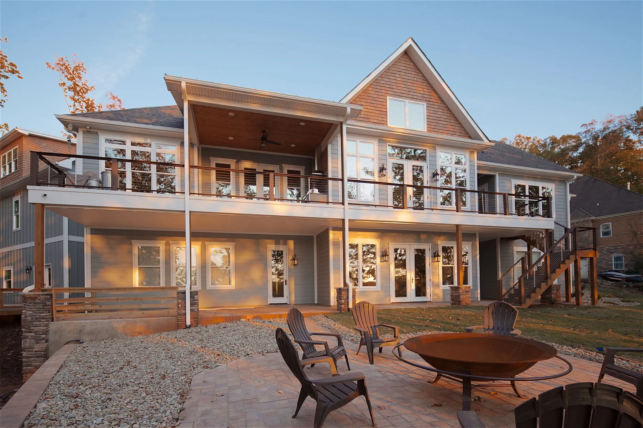 Full rear elevation of the lake house with terraces and patio