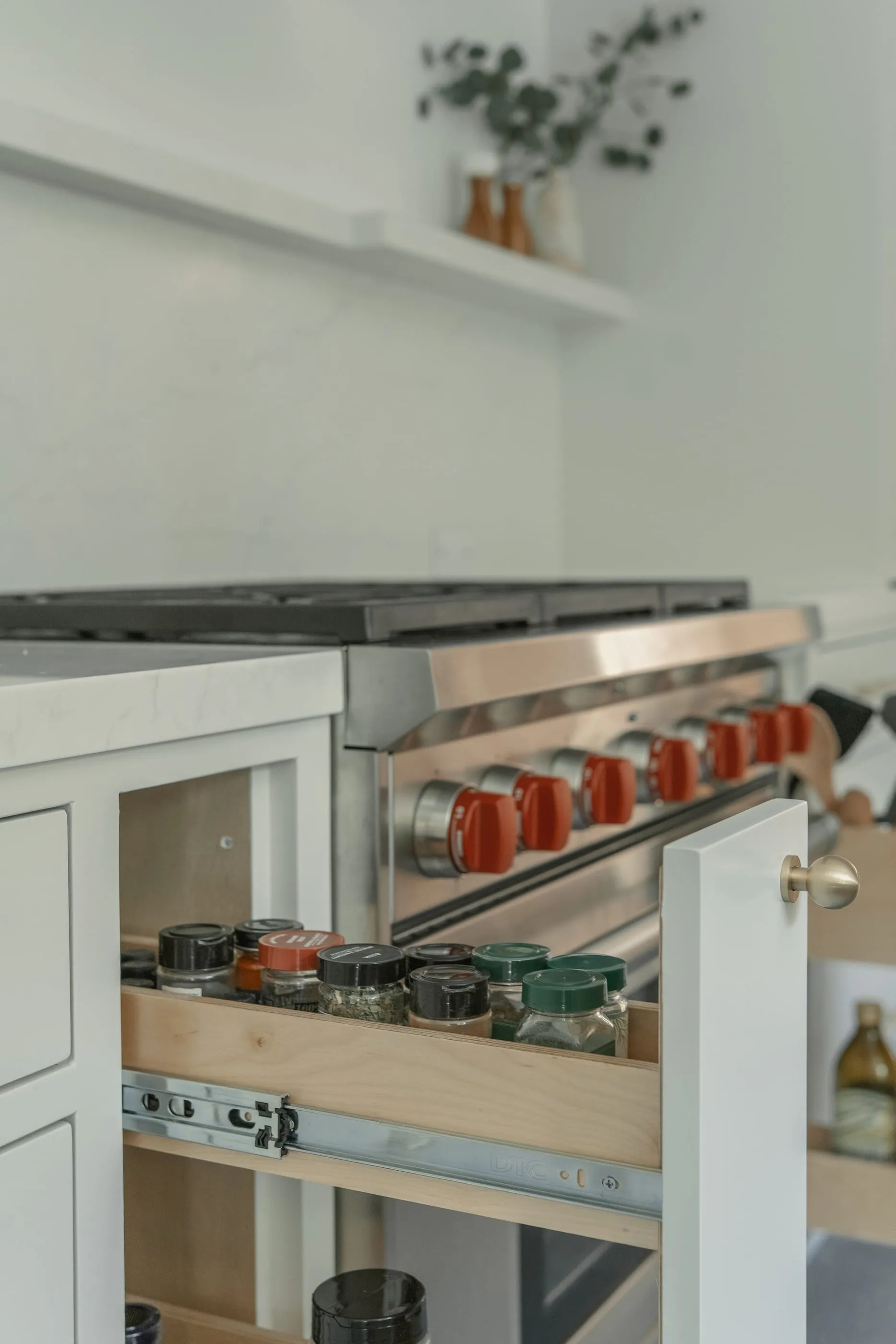 Pull-out spice drawer beside the stainless range